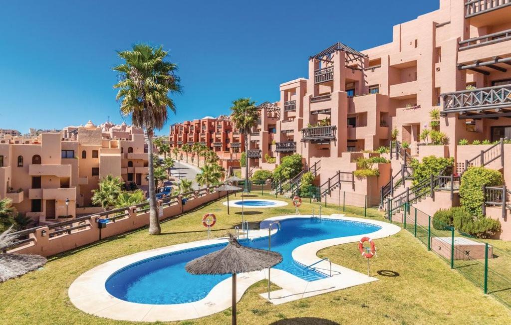 an apartment with a swimming pool and some buildings at 2311-modern apt with sea and pool views in San Luis de Sabinillas