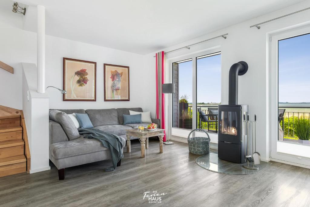 a living room with a couch and a fireplace at Bellevue in Olpenitz