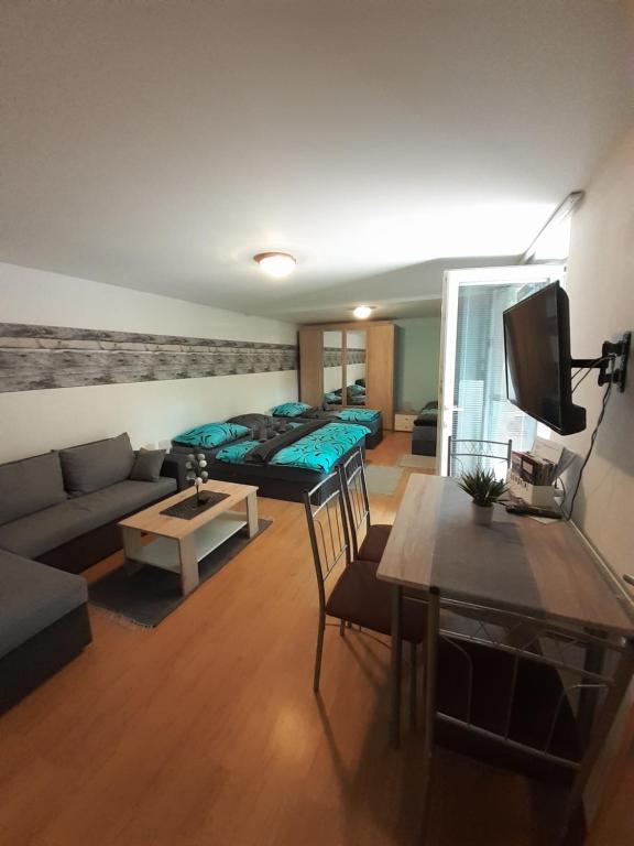 a living room with a couch and a bed at Apartmán LauMar 2 in Bzenec