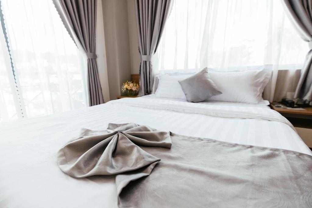Postel nebo postele na pokoji v ubytování Minh Chi Hotel