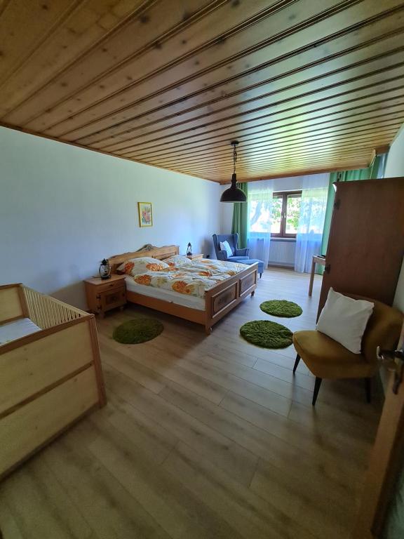 a bedroom with a large bed and a wooden ceiling at FEWO Paternoster in Regen