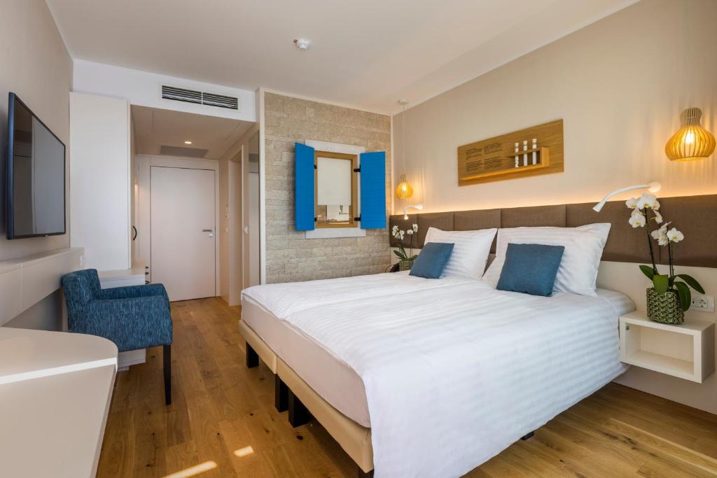 Postel nebo postele na pokoji v ubytování Hotel Histrion