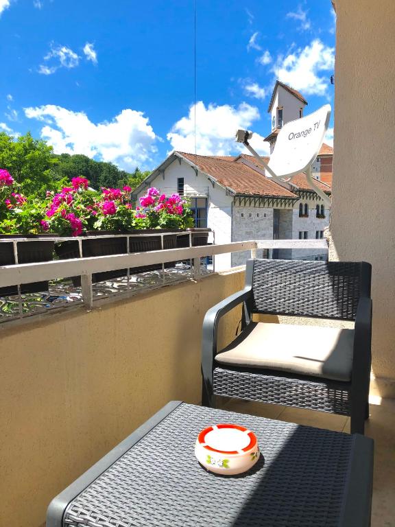 a balcony with a table and chairs and flowers at Apartament Stefan in Băile Govora