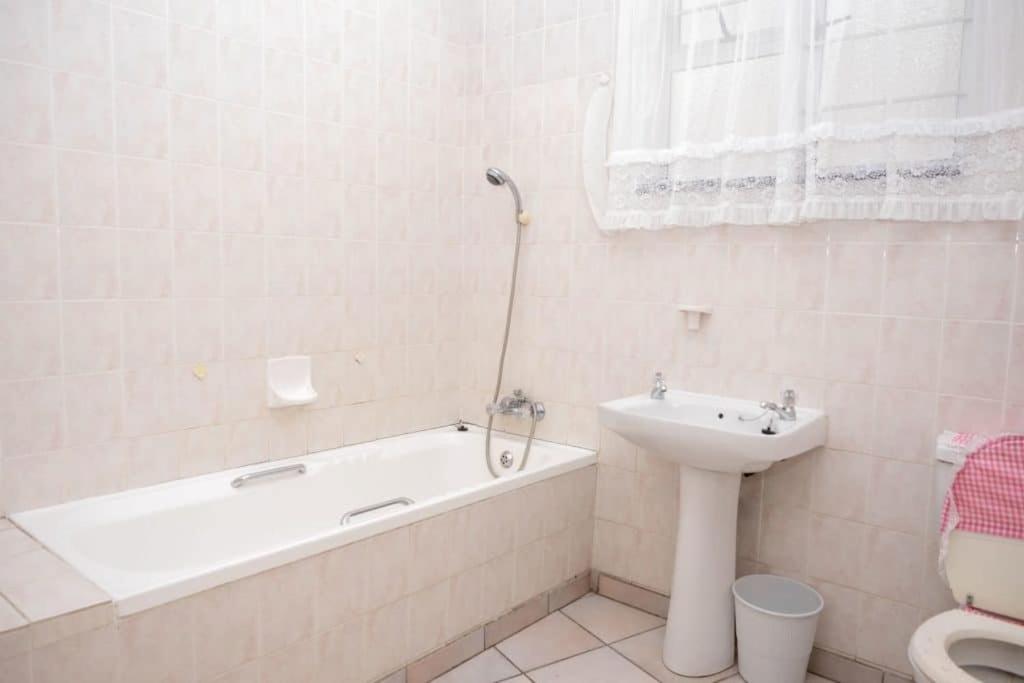 a bathroom with a tub and a sink and a toilet at Seabrook 211 Margate RSA in Margate