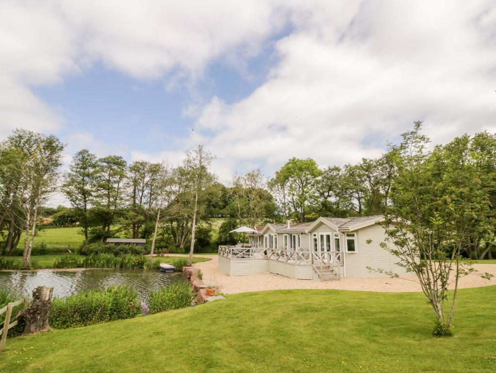 a house with a garden and a pond at Phocle Lodge in Ross on Wye