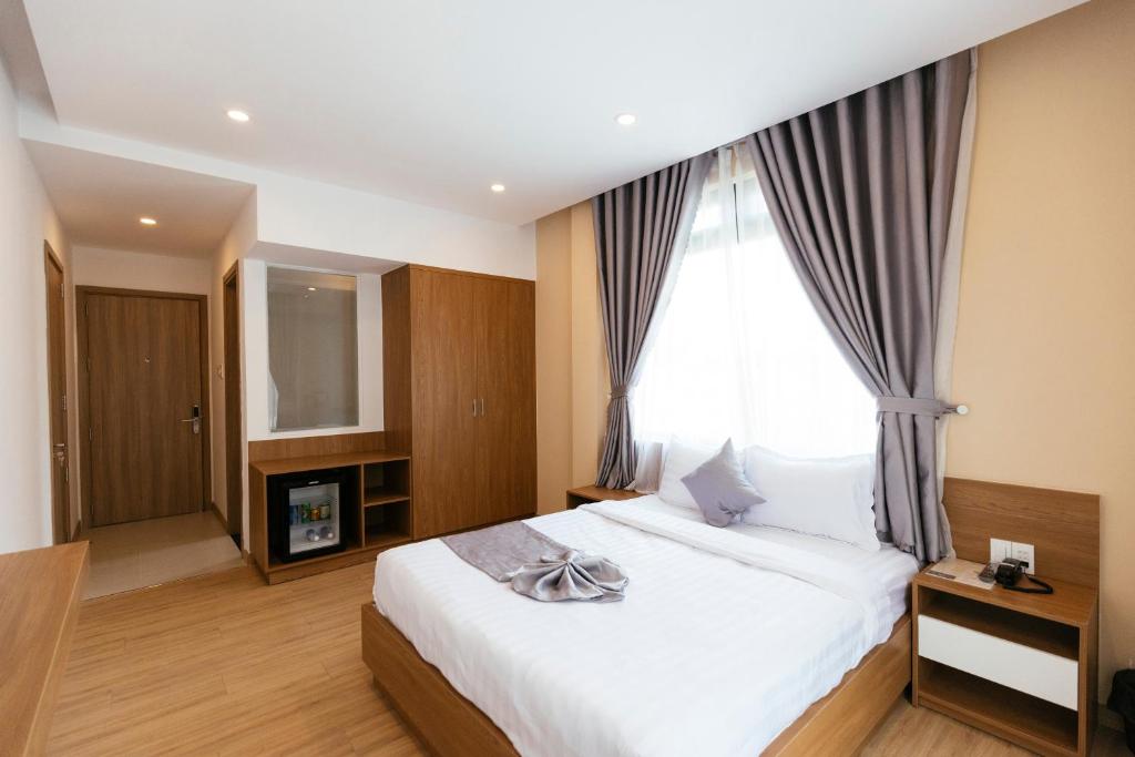 Postel nebo postele na pokoji v ubytování Minh Chi Hotel