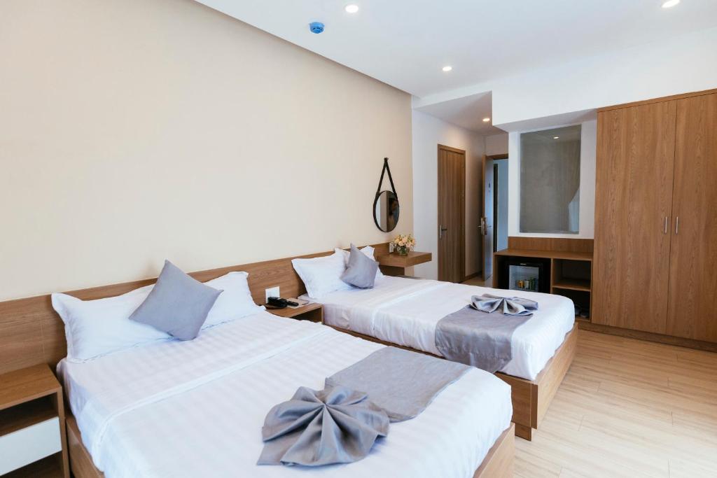 Postel nebo postele na pokoji v ubytování Minh Chi Hotel