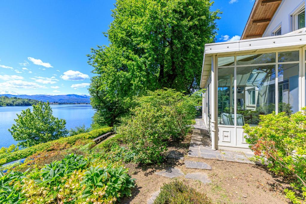 a home with a view of the water at Villa Berenice Au Bord Du Lac in Comabbio