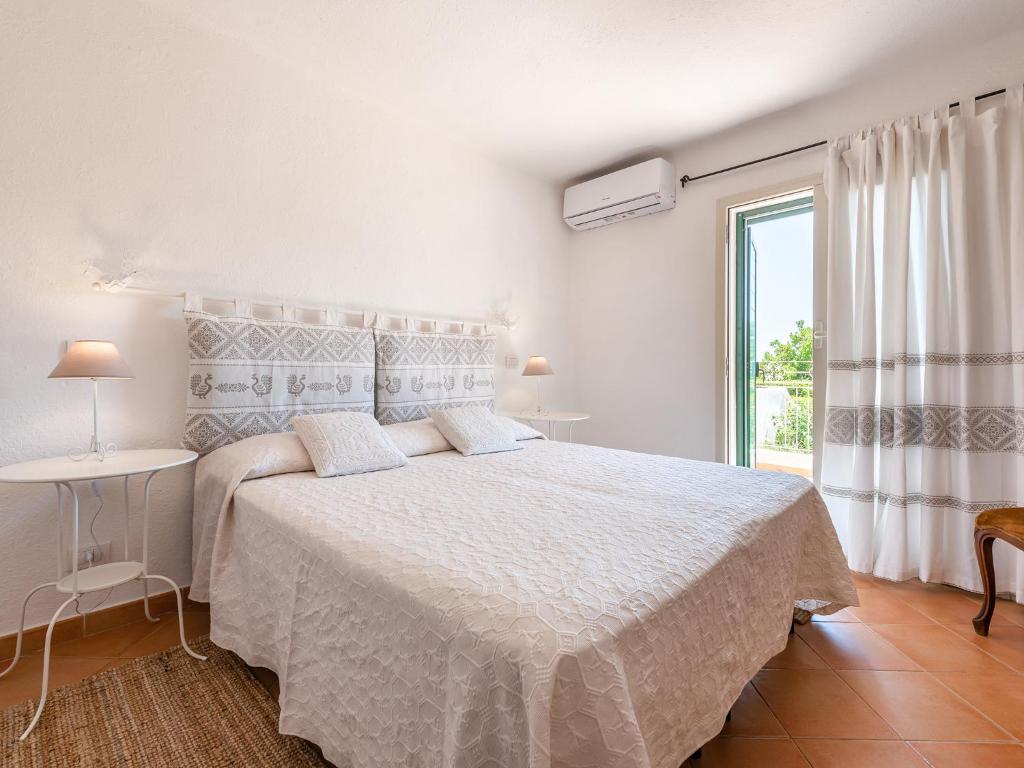 Postel nebo postele na pokoji v ubytování Relais Baia di Nelson