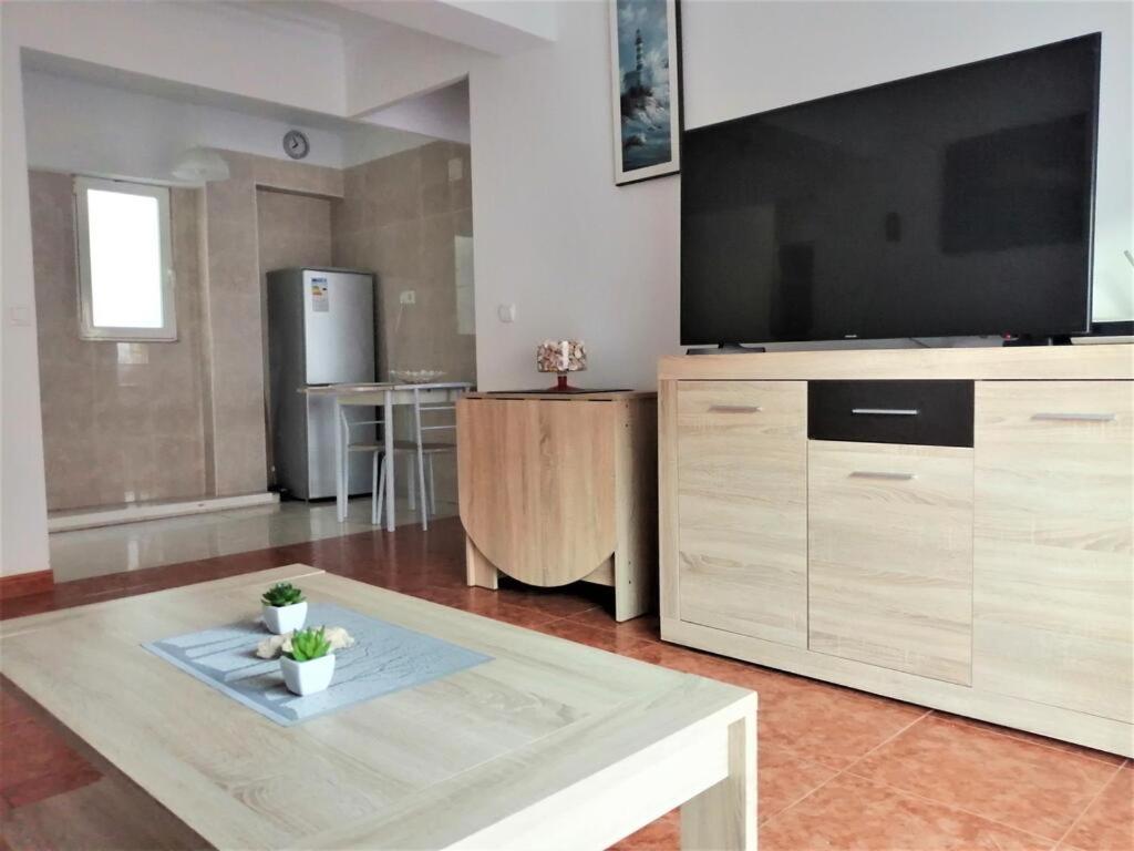 a living room with a large flat screen tv at Joan Apartment Gandia in Gandía