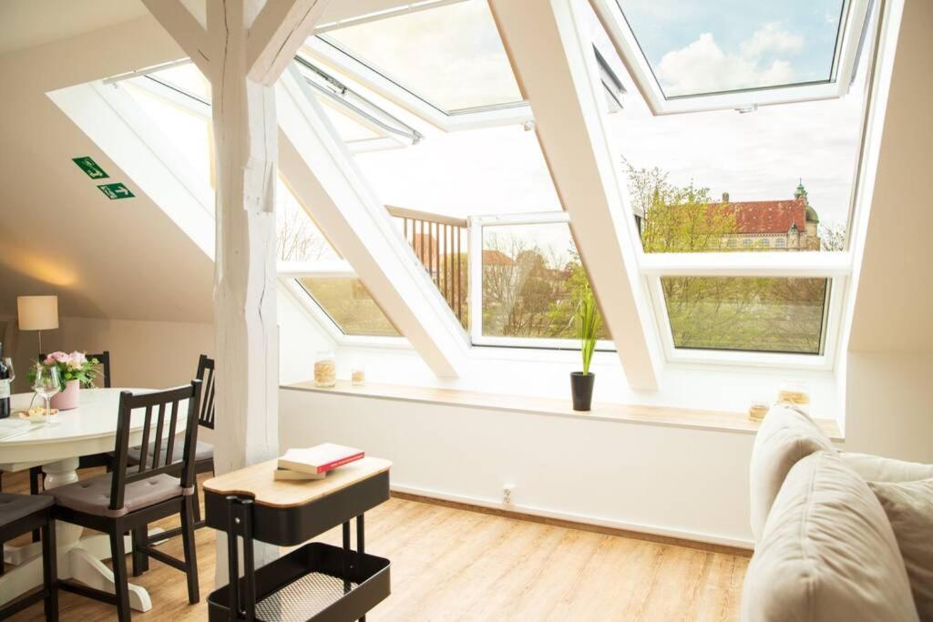 a living room with skylights and a table and a couch at Ferienwohnung Schlossblick in Güstrow