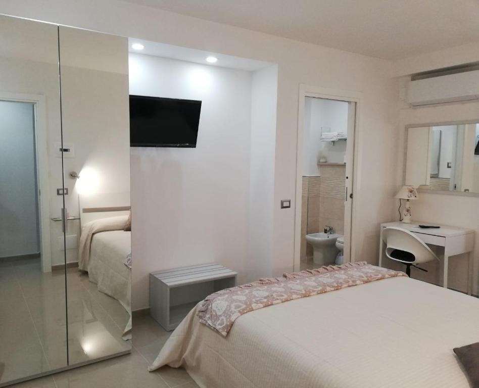A bed or beds in a room at B&B Oplonti Resort
