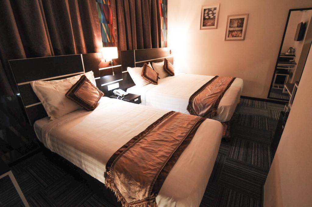 Postel nebo postele na pokoji v ubytování K Garden Hotel Parit Buntar