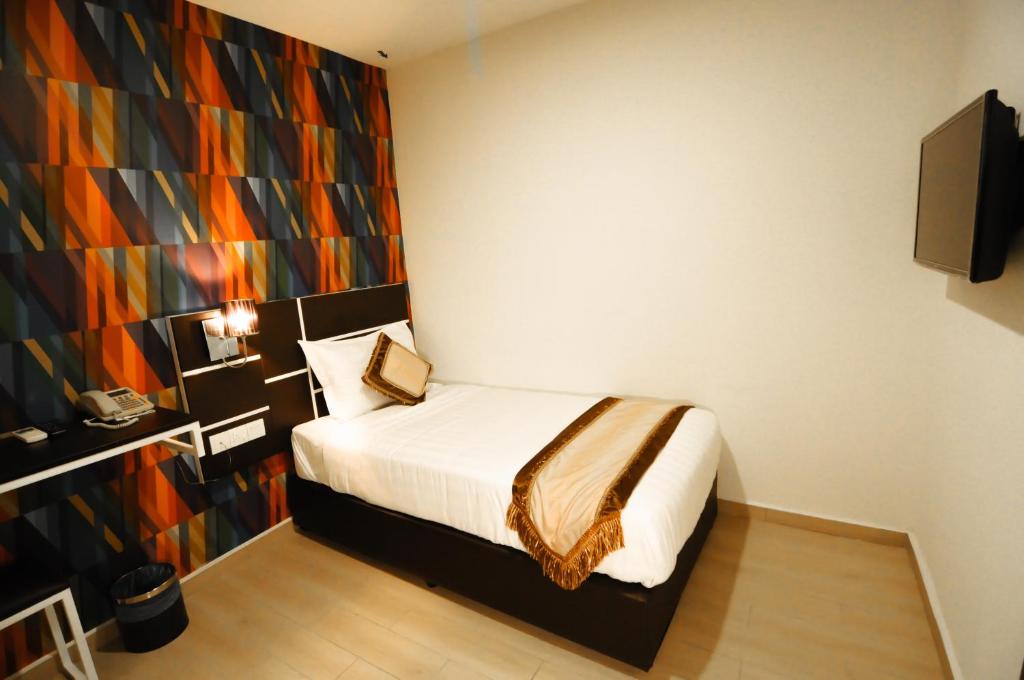 Postel nebo postele na pokoji v ubytování K Garden Hotel Parit Buntar