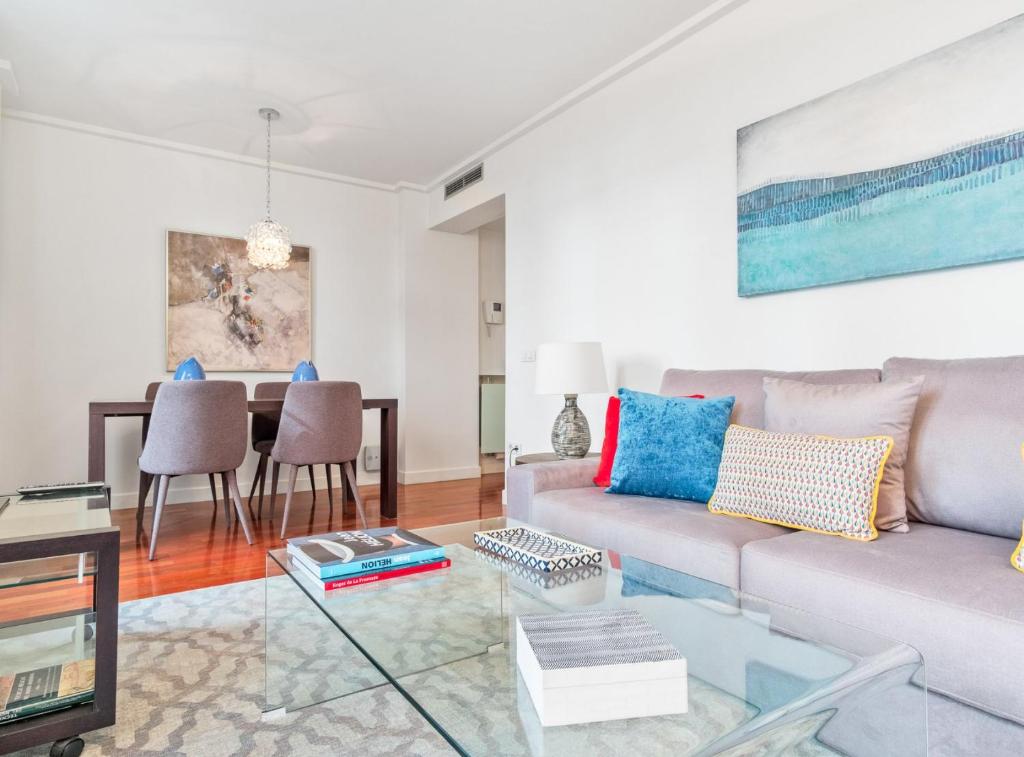 a living room with a couch and a table at Retiro VI in Madrid