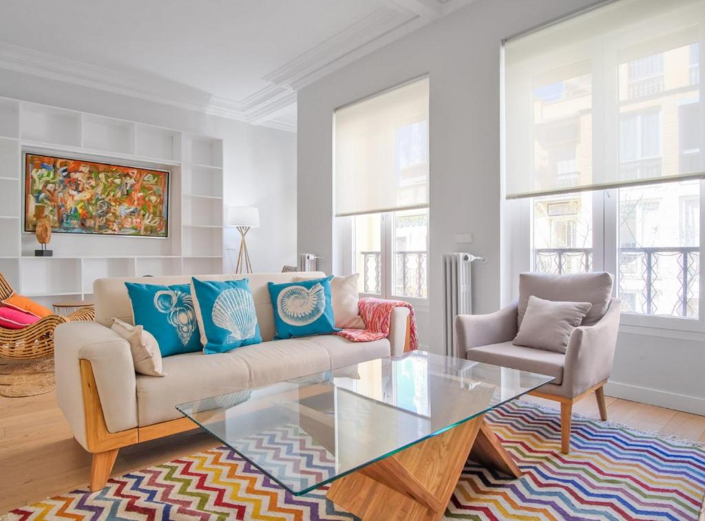 a living room with a couch and a glass table at CASTELLO IV in Madrid