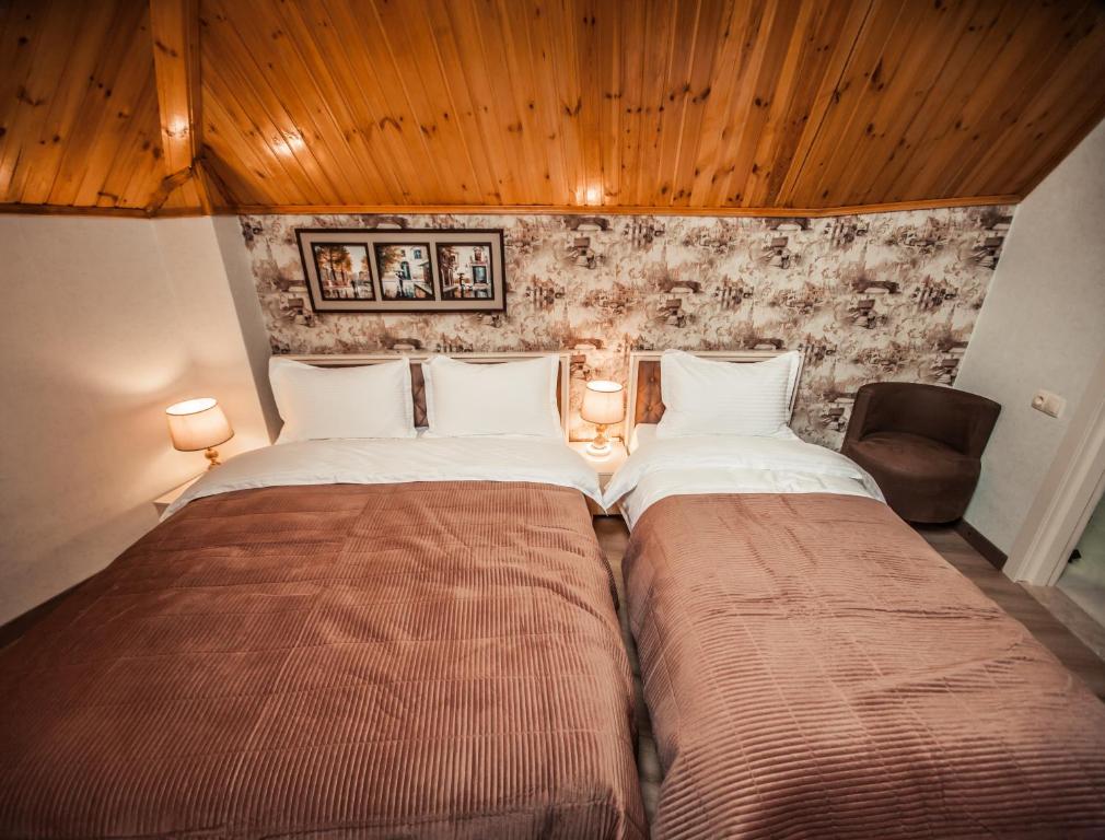 Postel nebo postele na pokoji v ubytování MUSMORE Boutique Hotel