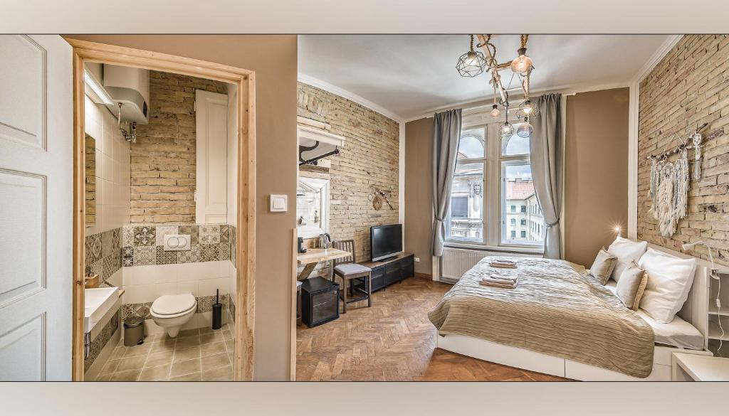 Postel nebo postele na pokoji v ubytování Boutique Suites Ráday