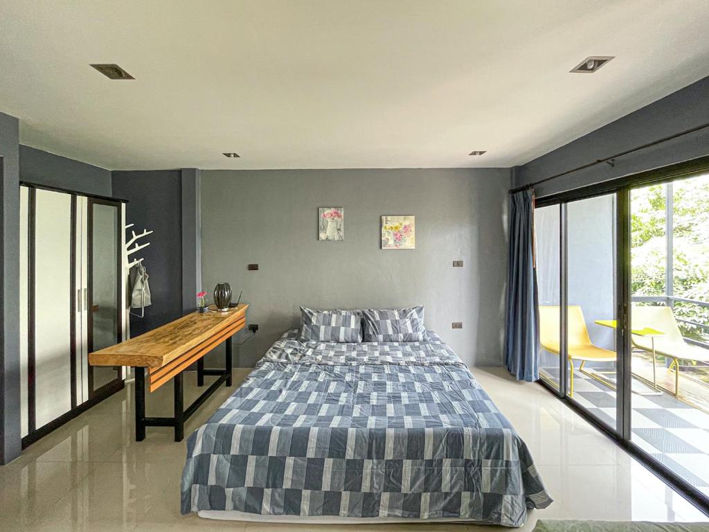 a bedroom with a bed and a wooden desk at The Endless Bangtao Residence LOFT 7 in Bang Tao Beach