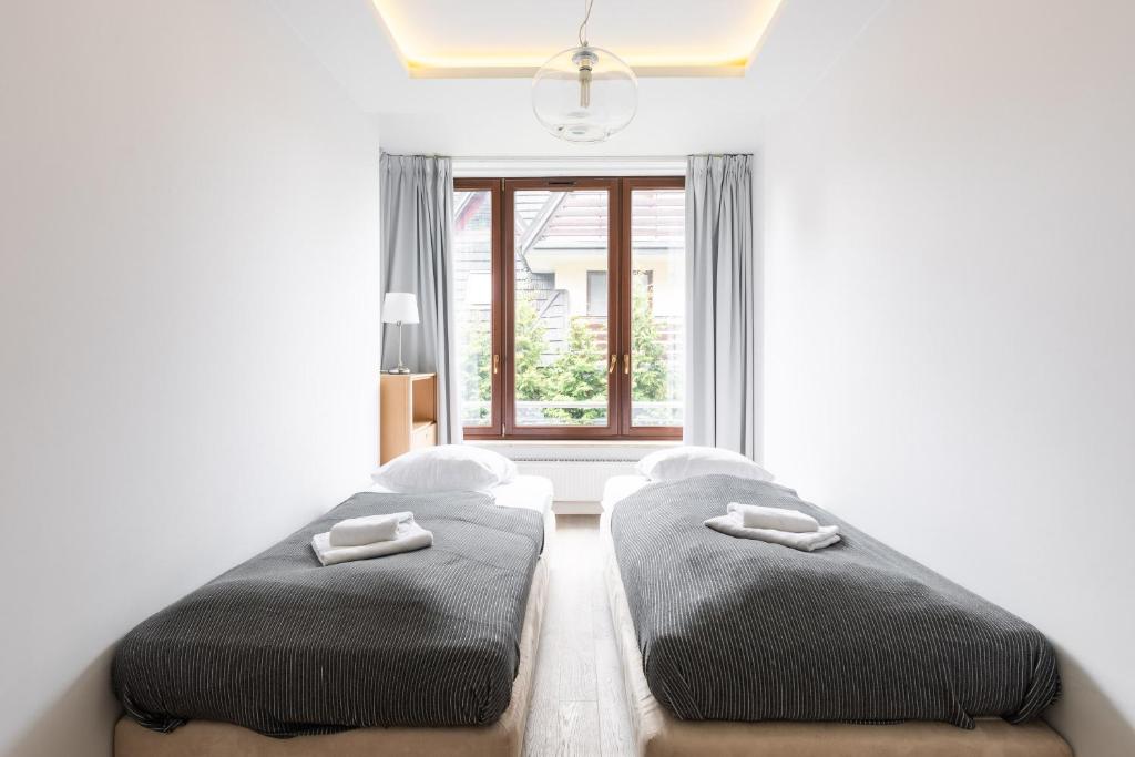Posteľ alebo postele v izbe v ubytovaní Apartamenty Oaza Deluxe Zakopane