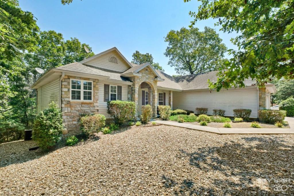 a house with a gravel driveway at Relaxing BV Home near Golfing, Hiking, & Lakes in Bella Vista