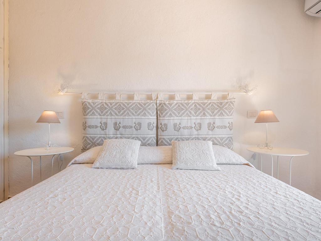 Postel nebo postele na pokoji v ubytování Relais Baia di Nelson