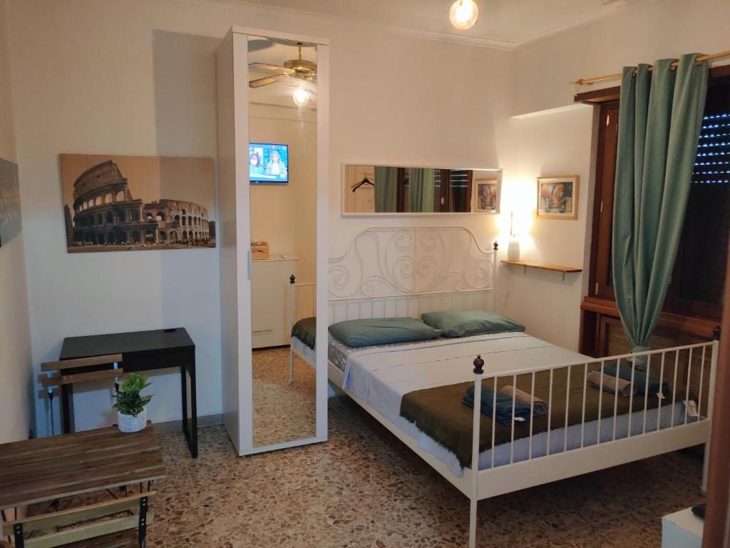 a small bedroom with a bed and a mirror at Roma Trastevere Station in Rome