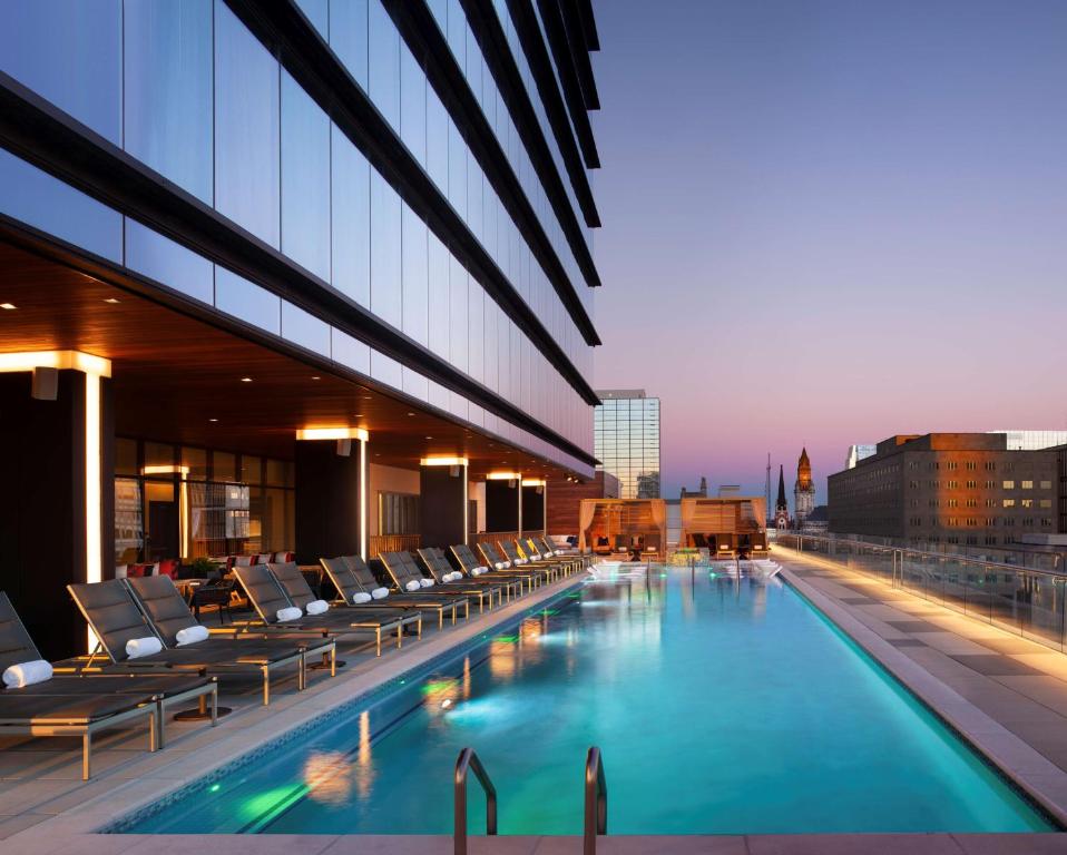 a pool on the roof of a building with lounge chairs at Grand Hyatt Nashville in Nashville