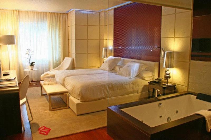 A bed or beds in a room at Gran Hotel Nagari Boutique & Spa