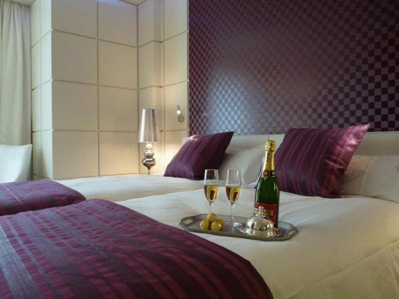 A bed or beds in a room at Gran Hotel Nagari Boutique & Spa
