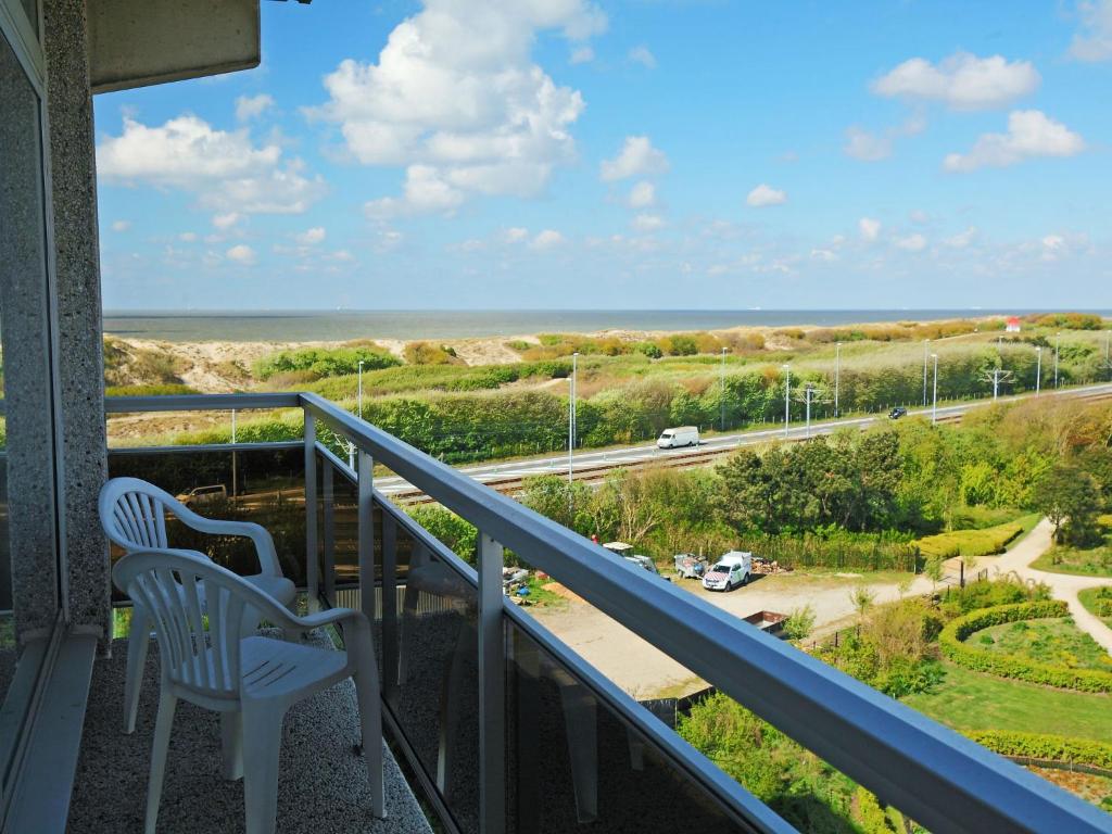 a balcony with two chairs and a view of the ocean at Apartment Residentie Astrid-1 by Interhome in Bredene