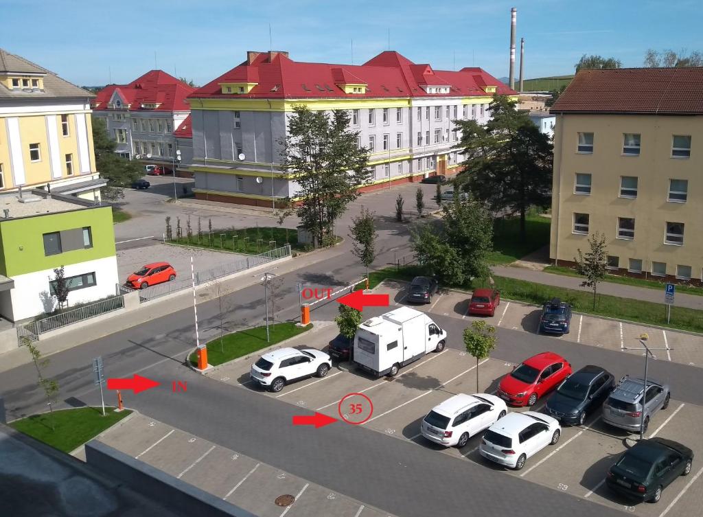 an aerial view of a parking lot with cars at Mountain View Studio Apartment in Poprad