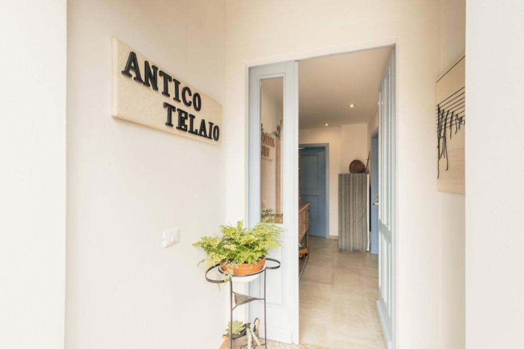 a hallway of an office building with a sign on the wall at B&B Antico Telaio in Santa Maria Navarrese