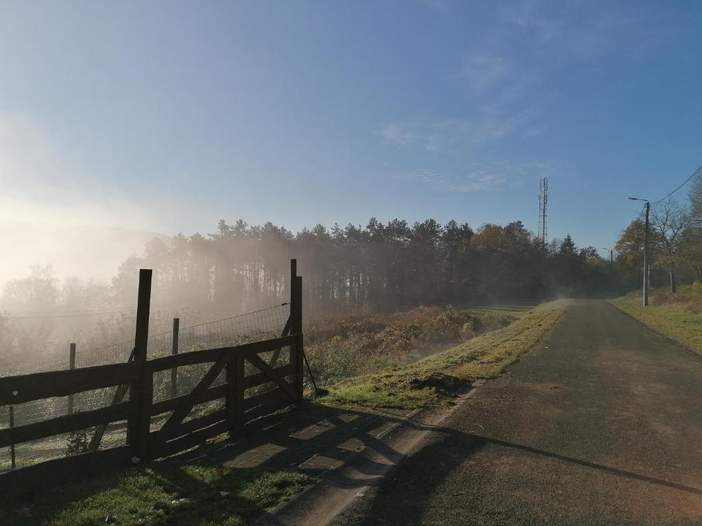 a fence on the side of a dirt road at Au repos de Zoé in Waulsort