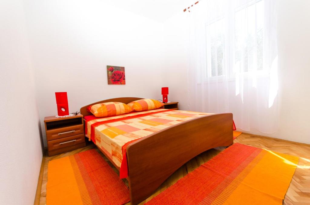 Postel nebo postele na pokoji v ubytování Apartments Ivana