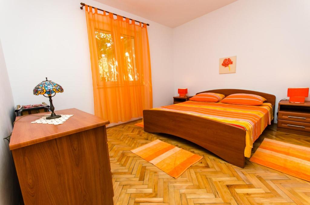 Postel nebo postele na pokoji v ubytování Apartments Ivana