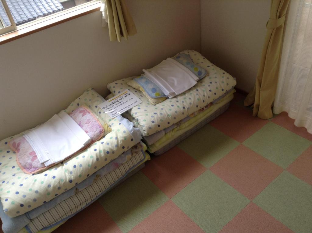 Postel nebo postele na pokoji v ubytování Kumamoto Guesthouse Minami Aso Little Asia