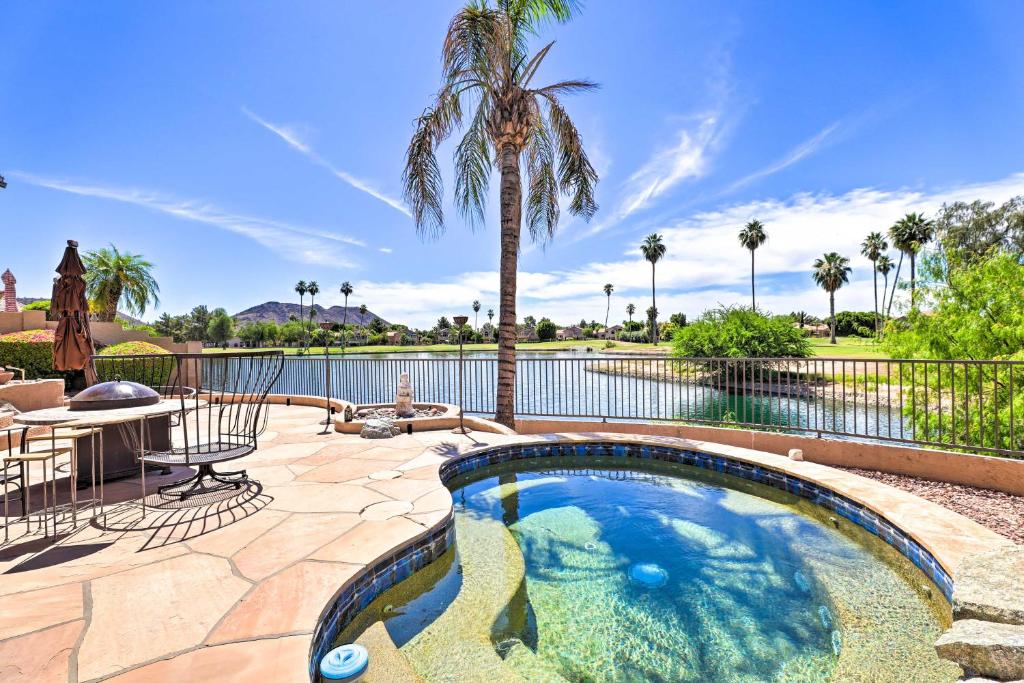 a swimming pool with a patio and a palm tree at Spa, Covered Patio Upscale Phoenix Oasis! in Peoria