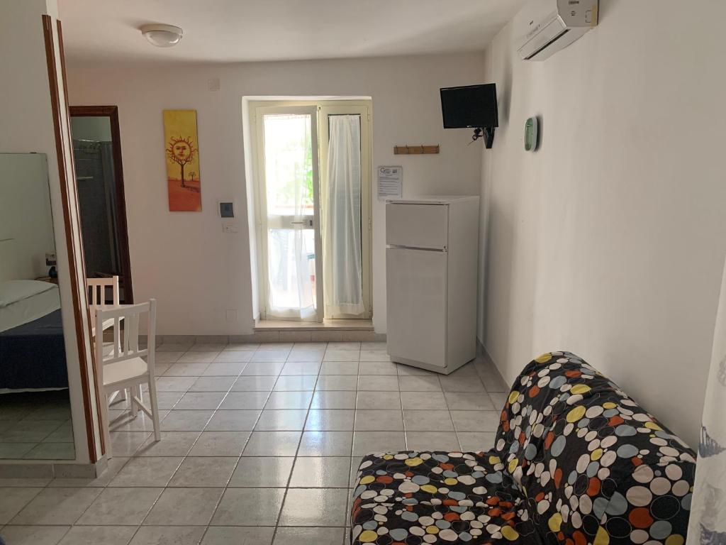 a living room with a couch and a refrigerator at Green Garden Eco-Holiday in Vieste