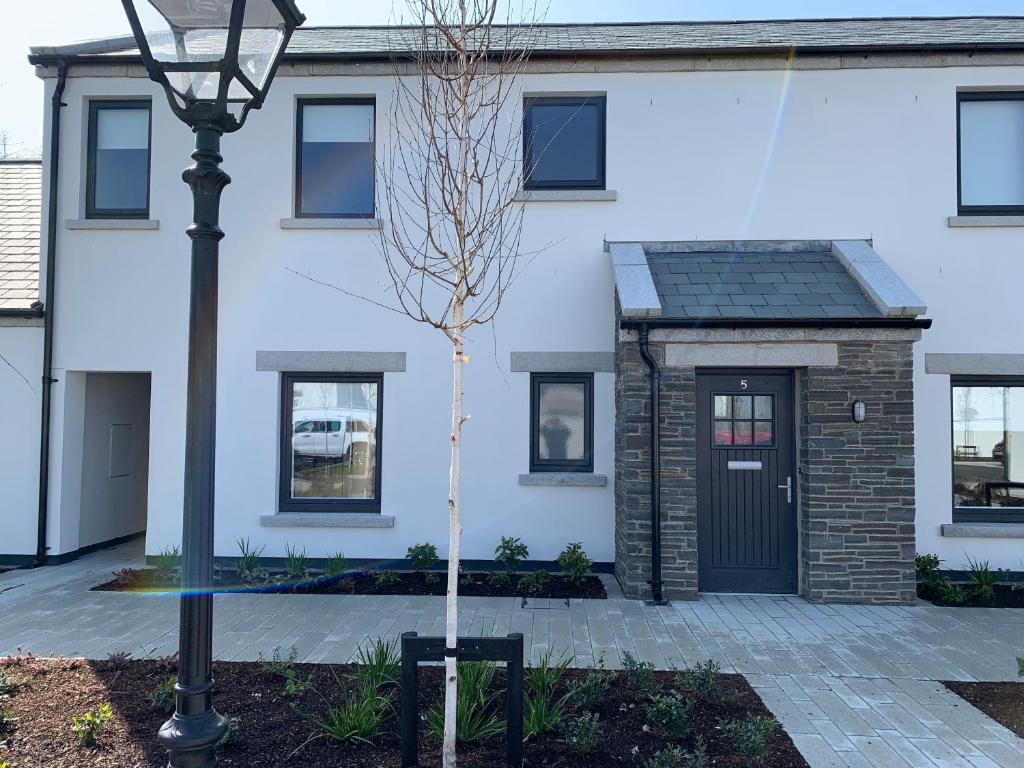 a house with a black door and a street light at Hilltown Lodges No5 in Hilltown