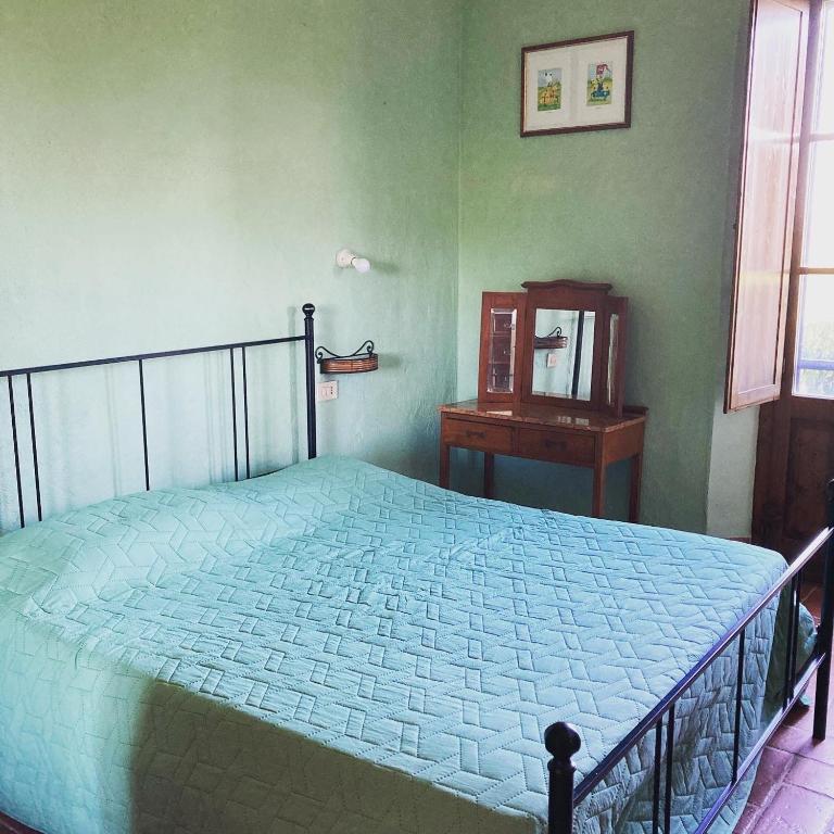 Postel nebo postele na pokoji v ubytování Agriturismo Le Tre Pietre - Podere nel Chianti