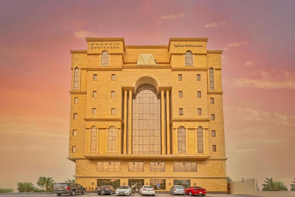 a building with cars parked in front of it at Makarem Residence - Hotel Apartments in Al Khobar