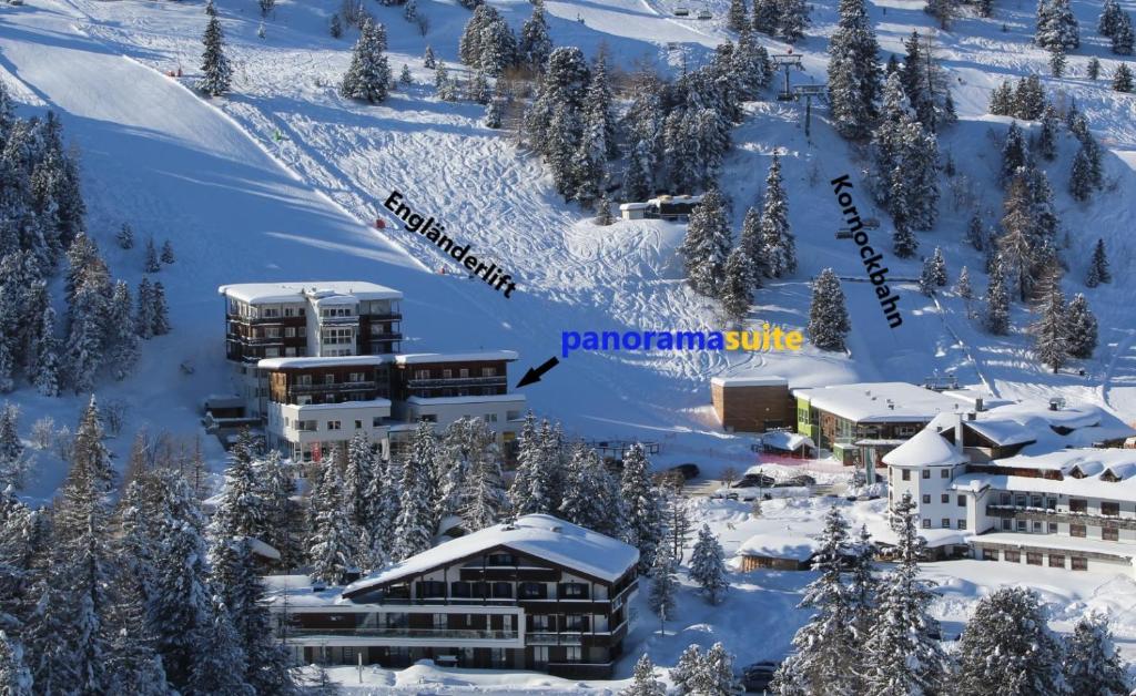 an aerial view of a resort in the snow at panoramasuite Turracherhöhe in Turracher Hohe