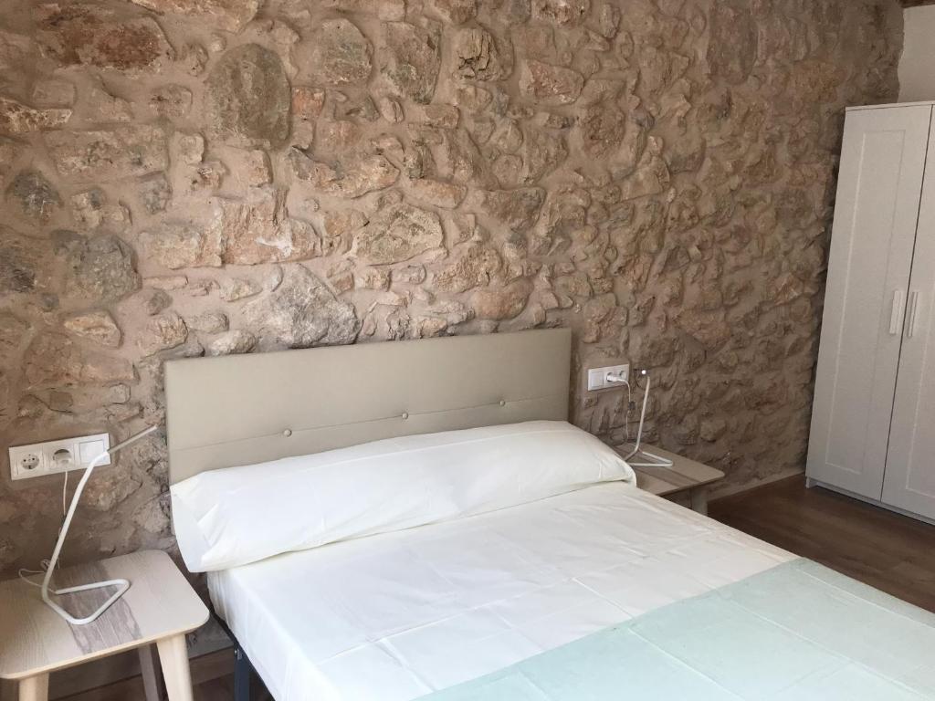 Postel nebo postele na pokoji v ubytování Apartaments Casa el Metge