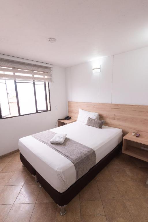 Postel nebo postele na pokoji v ubytování Hotel Cabo de la Vela Medellin