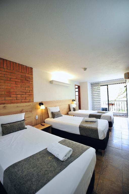 Postel nebo postele na pokoji v ubytování Hotel Cabo de la Vela Medellin