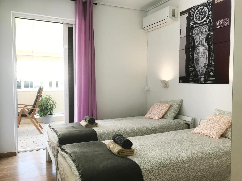 a bedroom with two beds with towels on them at Athens by foot: Perfect flat with terrace in Athens