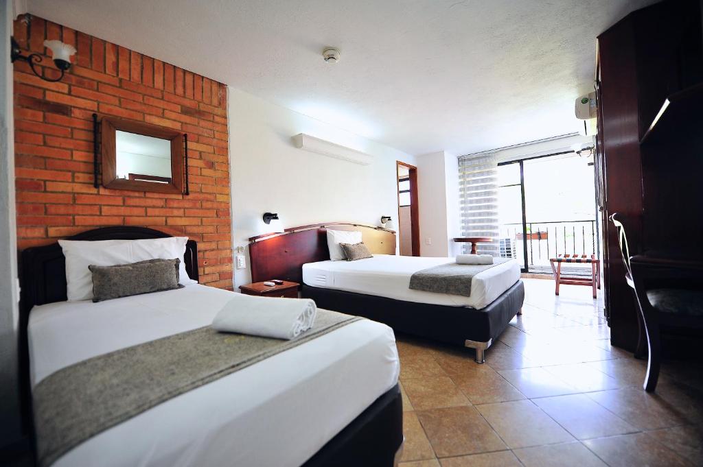 Postel nebo postele na pokoji v ubytování Hotel Cabo de la Vela Medellin