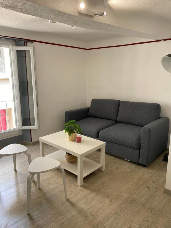 a living room with a couch and a table at Location de la Carraire in Valensole
