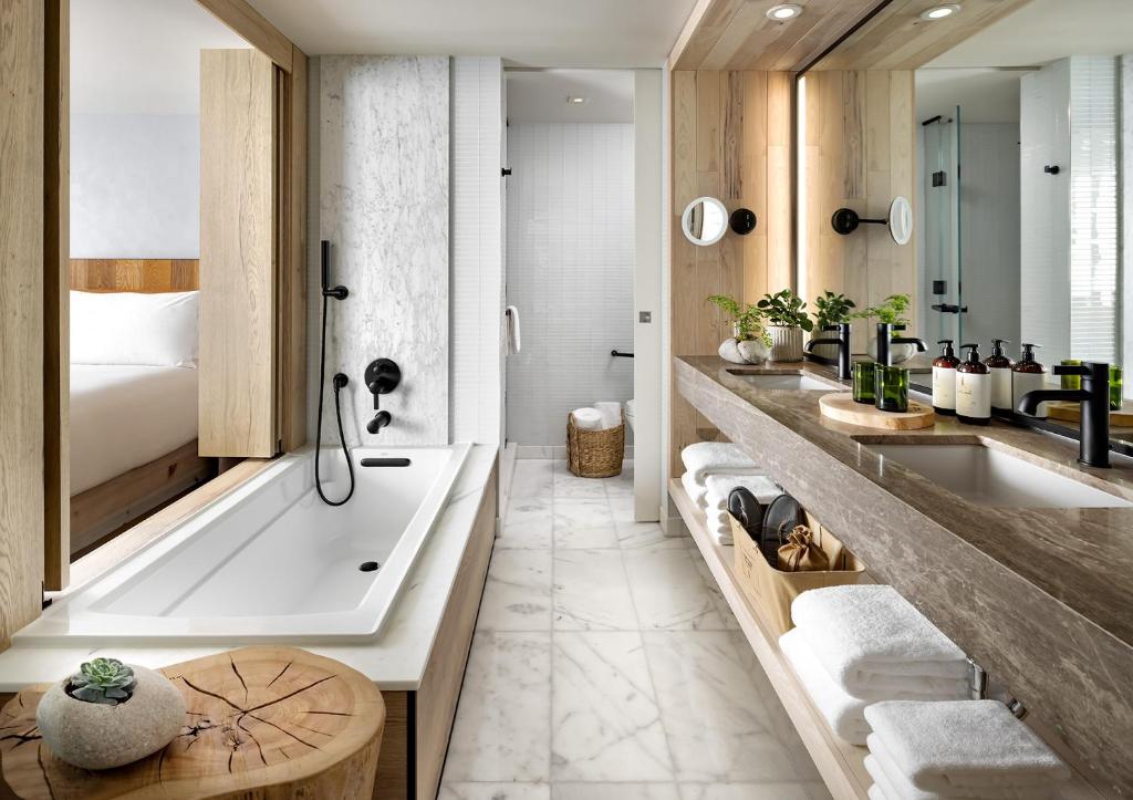 a bathroom with a tub and a sink at 1 Hotel Toronto in Toronto